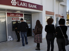 People queue to use an ATM outside of a Laiki Bank branch in Larnaca, Cyprus, on Saturday. Many rushed to cooperative banks after learning that the terms of a bailout deal with international lenders includes a one-time levy on bank deposits. People queue to use an ATM outside of a Laiki Bank branch in Larnaca, Cyprus, on Saturday. Many rushed to cooperative banks after learning that the terms of a bailout deal with international lenders includes a one-time levy on bank deposits.