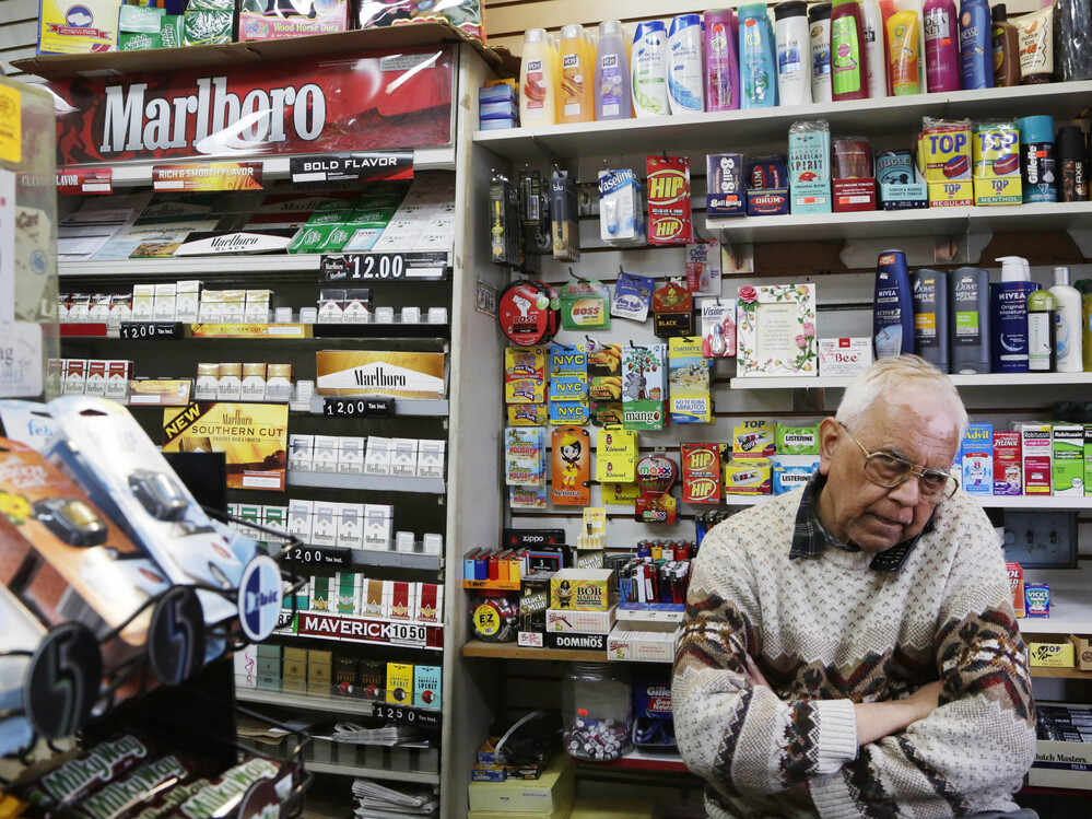 Harry Patel, an employee of Blondie's Deli and Grocery, talks on the phone while waiting for customers in New York on Monday. A new anti-smoking proposal would make New York the first city in the nation to keep tobacco products out of sight in retail stores.