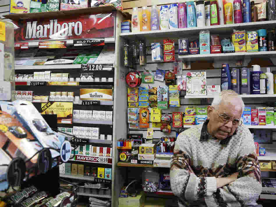 Harry Patel, an employee of Blondie's Deli and Grocery, talks on the phone while waiting for customers in New York on Monday. A new anti-smoking proposal would make New York the first city in the nation to keep tobacco products out of sight in retail stores.
