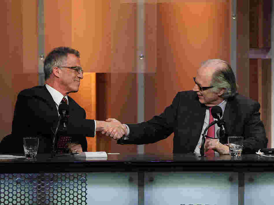 Debaters Frederic Mishkin and John Taylor celebrate their win after arguing that the U.S. doesn't need a strong dollar policy.