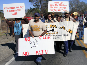 Led by the Rev. Willie Phillips (center), protesters march in February against violence in and around Club Majestic.