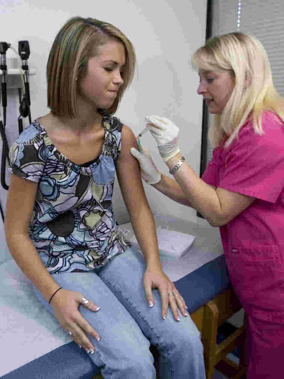 Lauren Fant winces as she receives her third and final shot of HPV vaccine from nurse Stephanie Pearson in Marietta, Ga., in 2007.