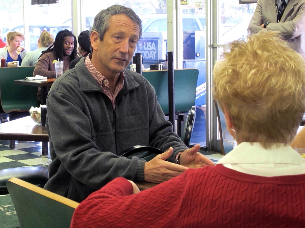 Former South Carolina Gov. Mark Sanford chats with a diner at a restaurant in Charleston, S.C. Sanford is one of 16 Republicans in Tuesday's GOP primary for the special election to fill the vacant 1st Congressional District seat.