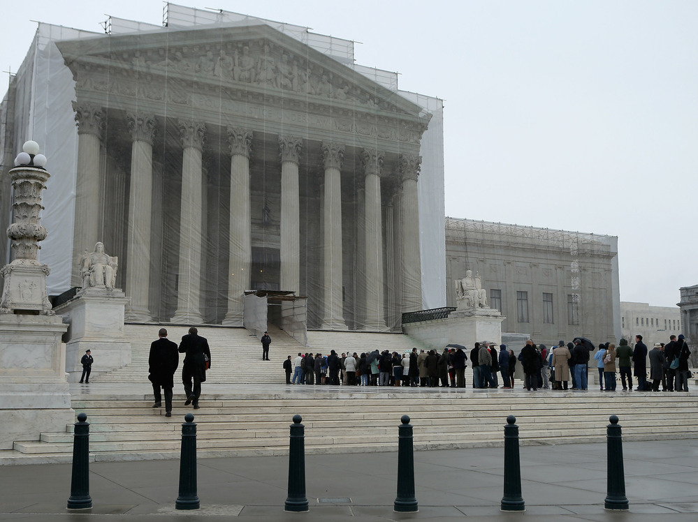 People stand in line outside the U.S. Supreme Court on Monday.