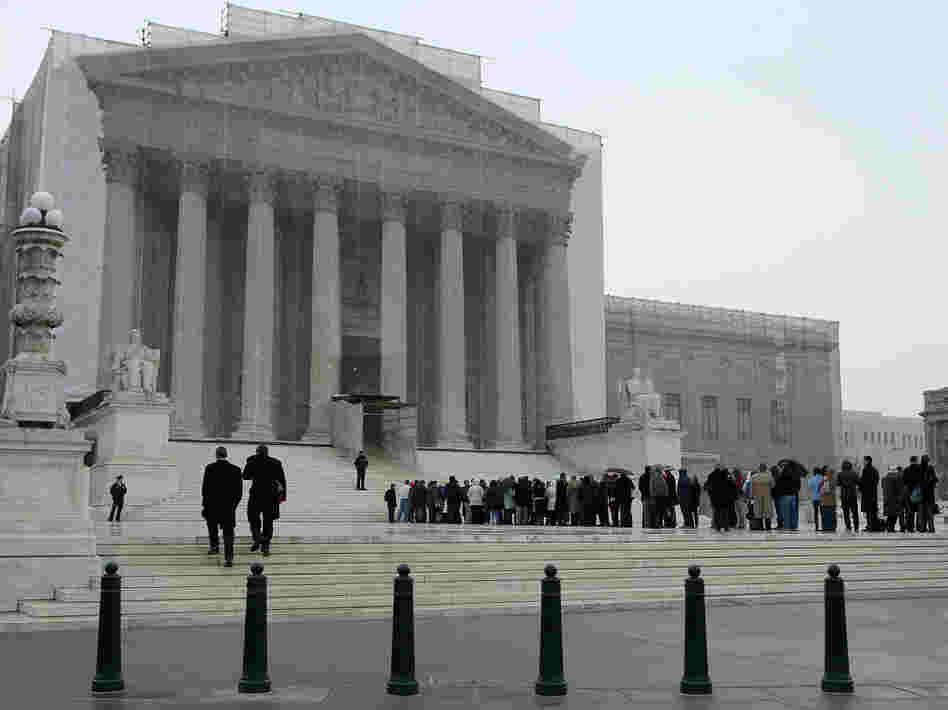 People stand in line outside the U.S. Supreme Court on Monday.