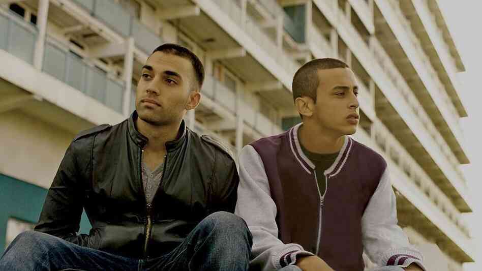 Brothers Rash and Mo (James Floyd and Fady Elsayed) live in the rough working-class London neighborhood of Hackney — but which sibling is the titular designee in My Brother the Devil gets harder and harder to determine as the film goes on. Brothers Rash and Mo (James Floyd and Fady Elsayed) live in the rough working-class London neighborhood of Hackney — but which sibling is the titular designee in My Brother the Devil gets harder and harder to determine as the film goes on.
