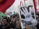 Protesters chant slogans outside the Cypriot parliament in central Nicosia, Tuesday, March 19, 2013.