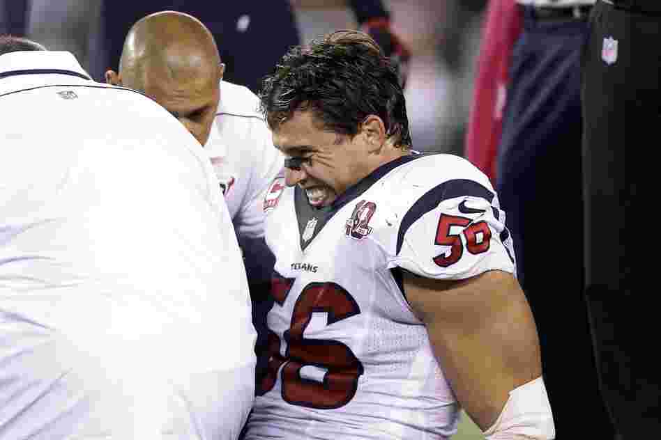 Trainers work on Houston Texans  linebacker Brian Cushing during the first half of an NFL football game against the New York Jets in 2012.