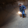 Grain Operator Austin Clubb surveys corn inside the Homestead Grain Facility at Amana Farms near Cedar Rapids, IA. Grain Operator Austin Clubb surveys corn inside the Homestead Grain Facility at Amana Farms near Cedar Rapids, IA.