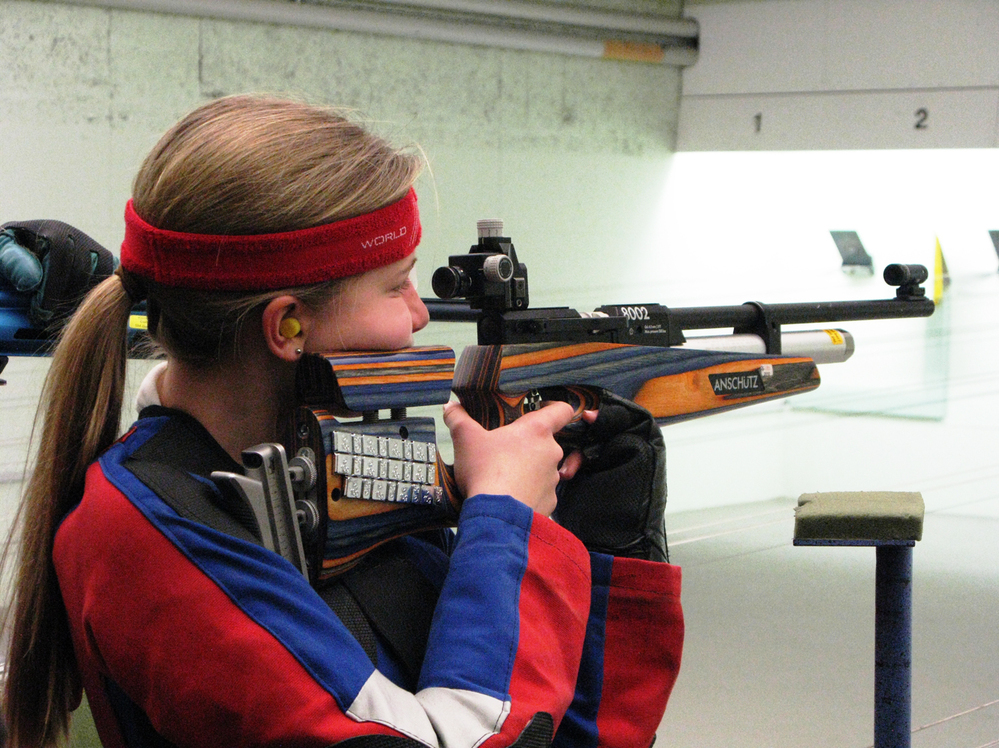 Greta Wolff, an 11-year-old immigrant from Germany, shoots during target practice at the gun club.