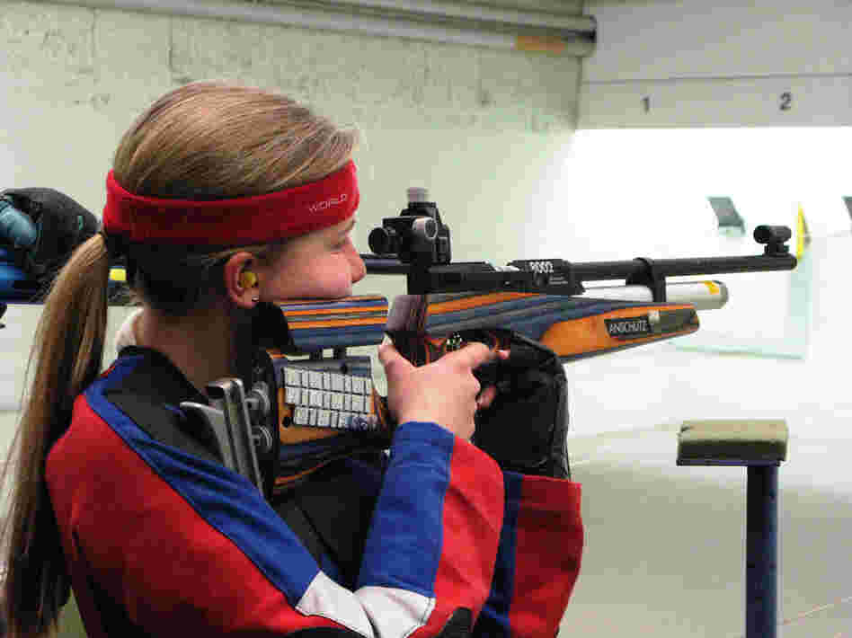 Greta Wolff, an 11-year-old immigrant from Germany, shoots during target practice at the gun club.