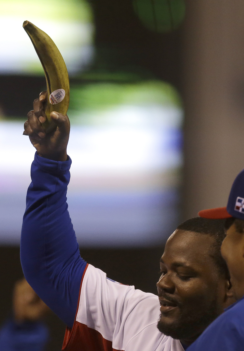 Dominican relief pitcher Fernando Rodney waves his lucky plantain following the win.