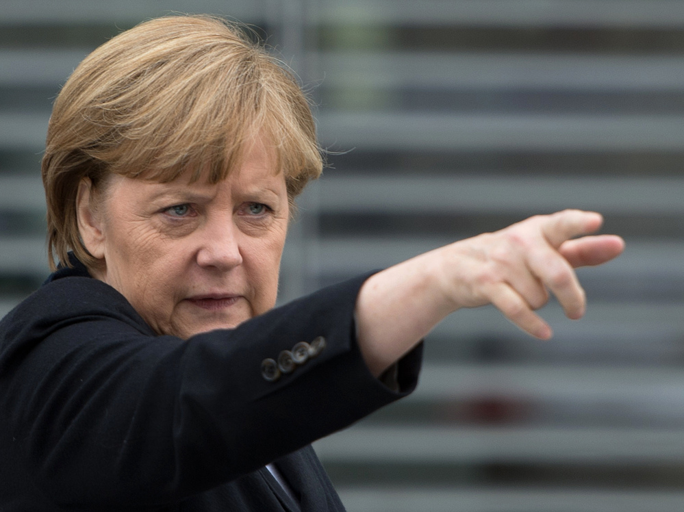 German Chancellor Angela Merkel gestures as she leaves a parliamentary session on Wednesday in Berlin.