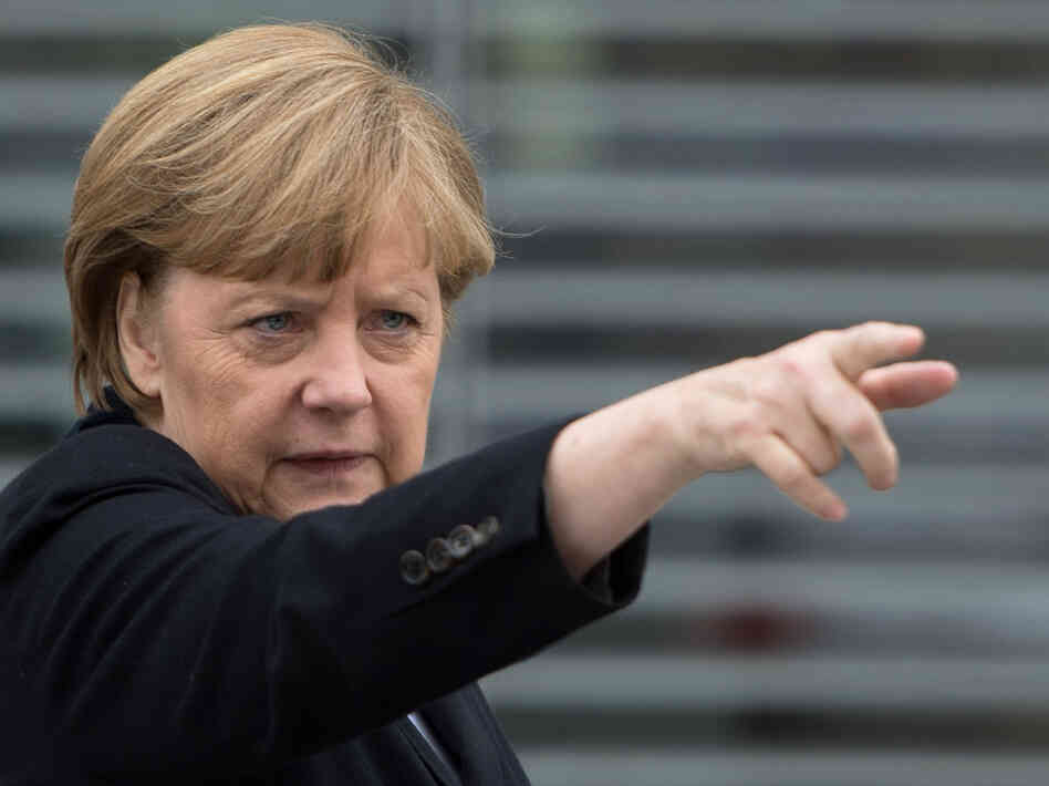 German Chancellor Angela Merkel gestures as she leaves a parliamentary session on Wednesday in Berlin.
