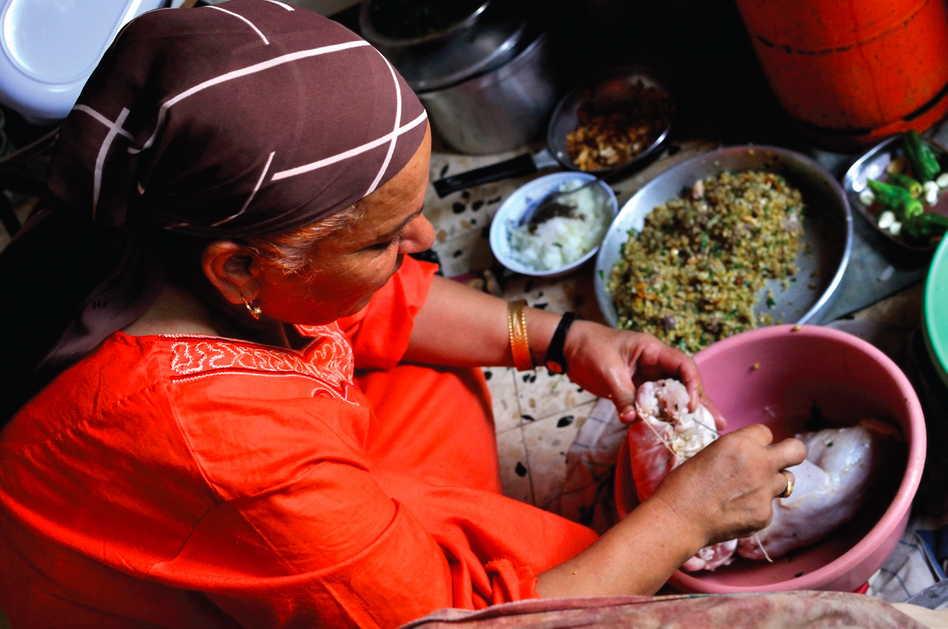 Fatema Qaadan prepares fatta, a meal of buttery rice and griddle bread served with roasted meat.