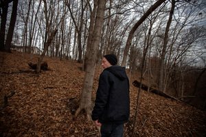 Piper walks in the woods behind his parents' home in Mount Carroll, Ill. He and Pacas were friends, and used to float on inner tubes in the nearby river.