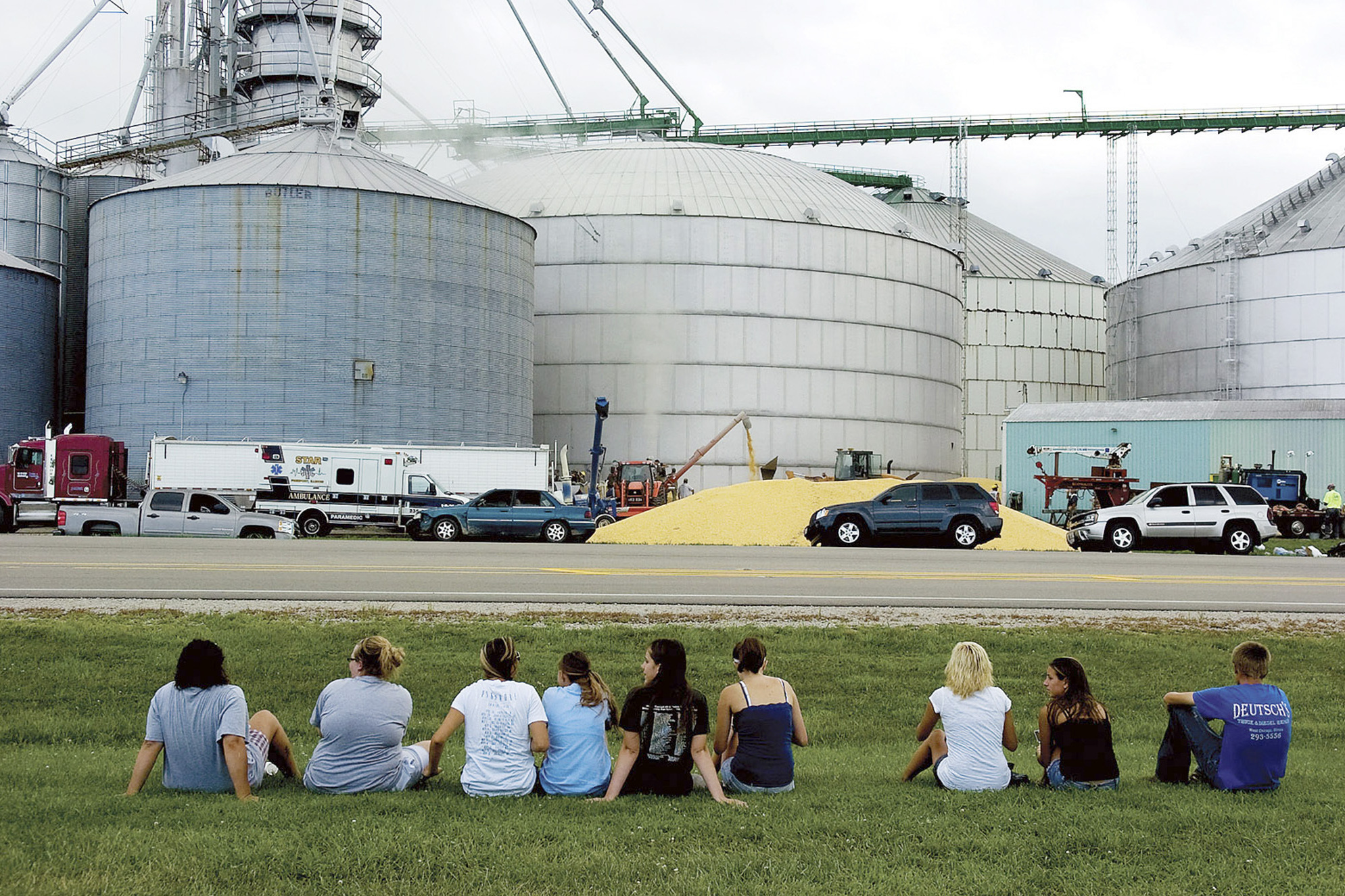 Friends and classmates of Wyatt Whitebread, Alex Pacas and Will Piper watch as rescuers work to free the boys from the bin (center) full of thousands of bushels of corn. Only Piper survived.