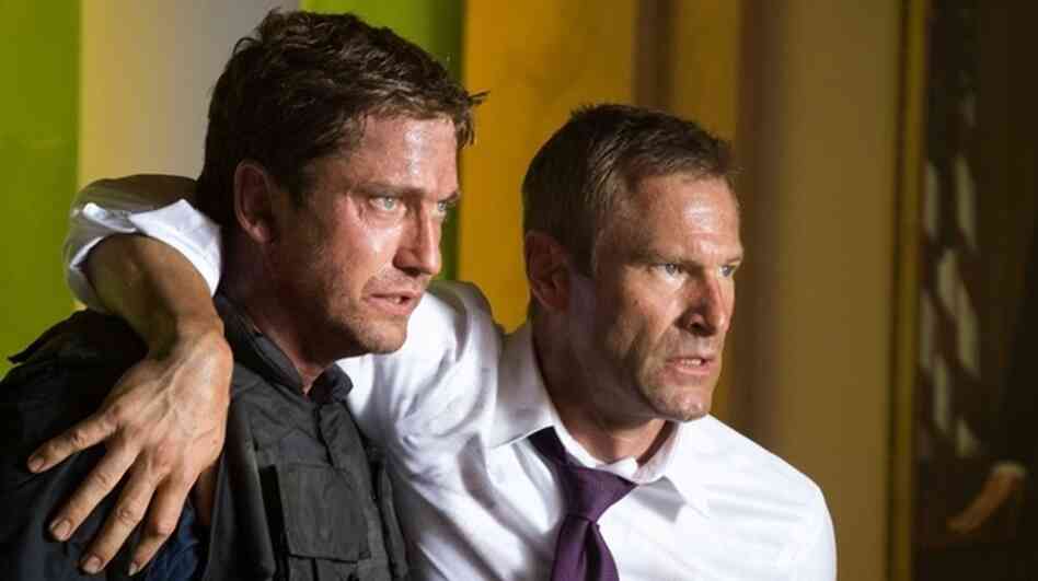 Mike Banning (Gerard Butler) and U.S. President Ben Asher (Aaron Eckhart) flee a destroyed White House in the military-political thriller Olympus Has Fallen. Mike Banning (Gerard Butler) and U.S. President Ben Asher (Aaron Eckhart) flee a destroyed White House in the military-political thriller Olympus Has Fallen.