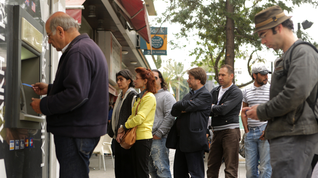 People line up at an ATM in Nicosia to withdraw cash on Thursday. (AFP/Getty Images)