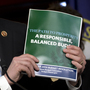 House Budget Committee Chairman Rep. Paul Ryan, R-Wis., holds a copy of his budget plan during a news conference last week. On Thursday, the Republican-controlled House narrowly passed the measure. The Senate is not expected to follow suit. House Budget Committee Chairman Rep. Paul Ryan, R-Wis., holds a copy of his budget plan during a news conference last week. On Thursday, the Republican-controlled House narrowly passed the measure. The Senate is not expected to follow suit.