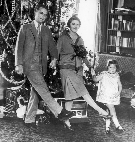 F. Scott Fitzgerald dances with his wife, Zelda, and daughter, Frances "Scottie," in front of a Christmas tree in Paris.