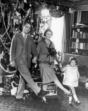 F. Scott Fitzgerald dances with his wife, Zelda, and daughter, Frances "Scottie," in front of a Christmas tree in Paris.