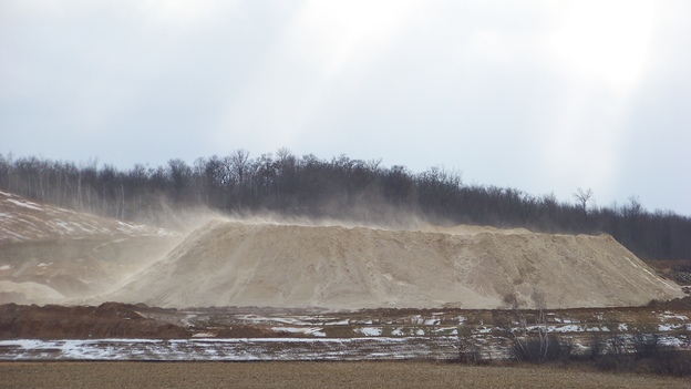 Dust blows off a pile of fracking sand at a mine near Chippewa Falls, Wis., on Dec. 15, 2011. Some of the air samples the National Institute for Occupational Safety and Health experts collected at fracking sites had such high levels of silica that the respirators typically worn by workers wouldn't offer enough protection, according to NIOSH standards.