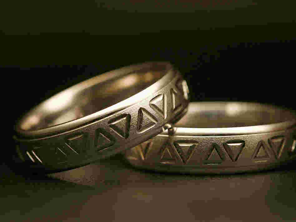 Same-sex wedding rings are engraved with triangles, a symbol of gay pride. Detractors say extending recognition to same-sex couples will weaken a bedrock institution meant to protect women and children.