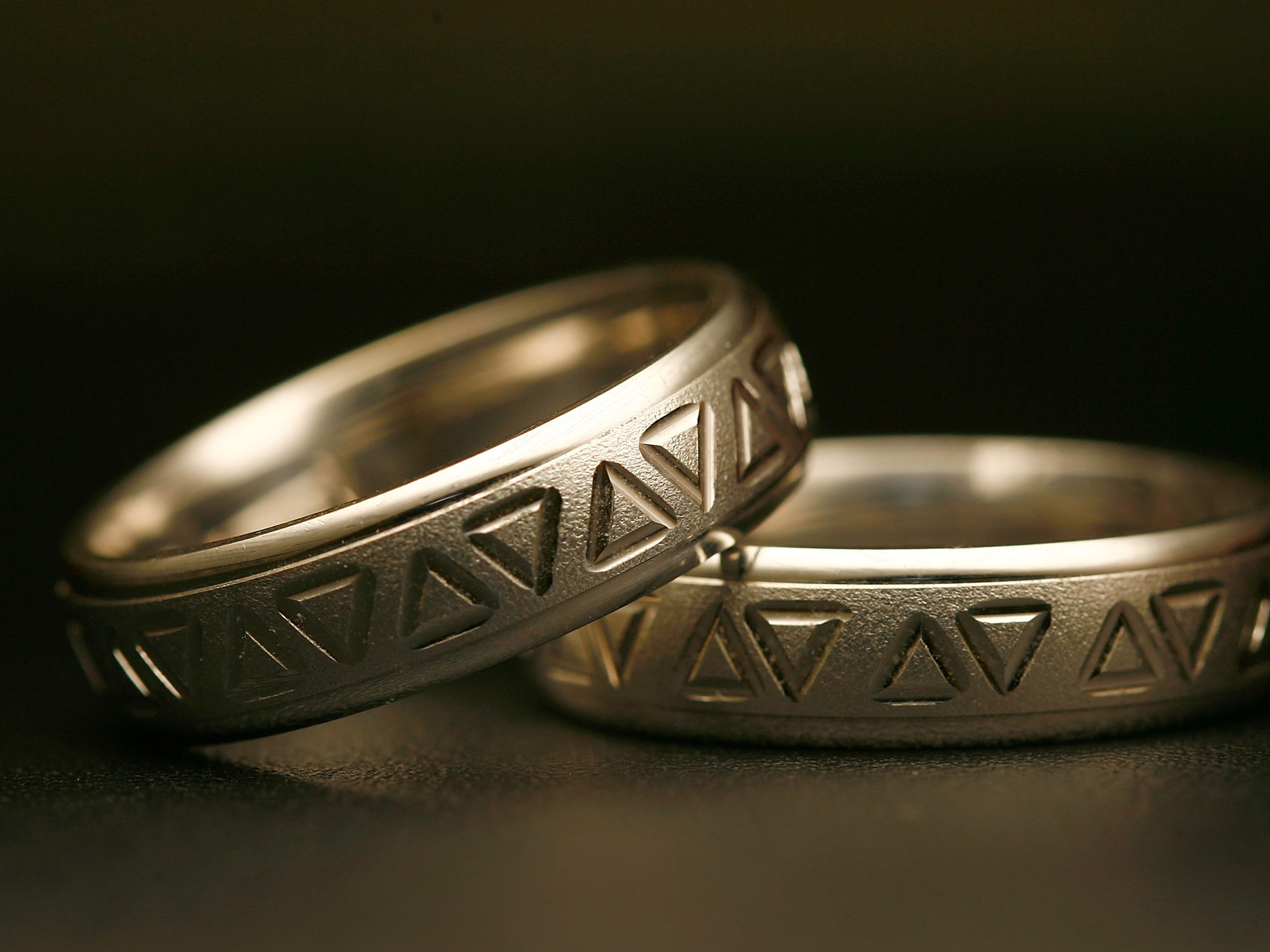 Same-sex wedding rings are engraved with triangles, a symbol of gay pride. Detractors say extending recognition to same-sex couples will weaken a bedrock institution meant to protect women and children. (Image credit: Getty Images)