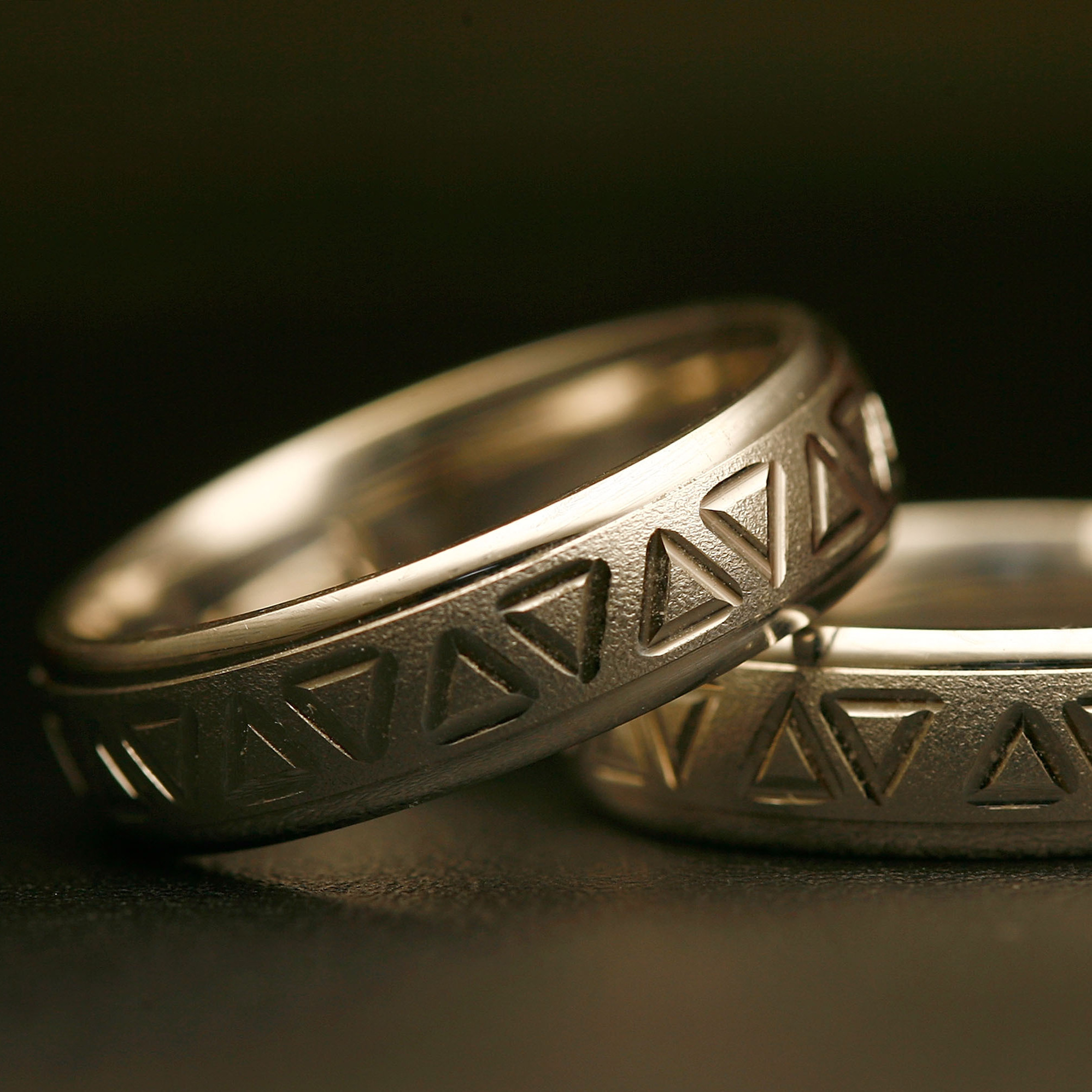 Same-sex wedding rings are engraved with triangles, a symbol of gay pride. Detractors say extending recognition to same-sex couples will weaken a bedrock institution meant to protect women and children.