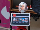 Future Robot's FURo robot acts as a host. Future Robot's FURo robot acts as a host.