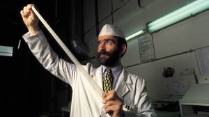A man tests the quality of a latex condom at a factory.