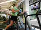 Chick-Fil-A employees Jennifer Cummins, right, and Joshua Figaretti work out in the gym during lunch at the company's corporate headquarters office in Hapeville, Ga. Increasingly employers are offering health plan incentives to encourage healthy behaviors from workers. Chick-Fil-A employees Jennifer Cummins, right, and Joshua Figaretti work out in the gym during lunch at the company's corporate headquarters office in Hapeville, Ga. Increasingly employers are offering health plan incentives to encourage healthy behaviors from workers.