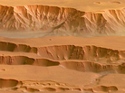 Coprates Chasma in the Valles Marineris on Mars, photographed by the Mars Express spacecraft. Appearing in the top half of this image, it ranges from 60-100 km wide and drops 8-9 km below the surrounding plains. Coprates Chasma in the Valles Marineris on Mars, photographed by the Mars Express spacecraft. Appearing in the top half of this image, it ranges from 60-100 km wide and drops 8-9 km below the surrounding plains.