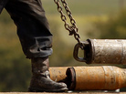 A worker hooks up pipe during natural gas drilling by EnerVest on the Barnett Shale near Fort Worth, Texas, in 2012. A worker hooks up pipe during natural gas drilling by EnerVest on the Barnett Shale near Fort Worth, Texas, in 2012.