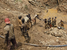 Gold miners pass up pans of sediment from an open-cast mine near the town of Mongbwalu, in the eastern Democratic Republic of Congo, last April. Gold miners pass up pans of sediment from an open-cast mine near the town of Mongbwalu, in the eastern Democratic Republic of Congo, last April.