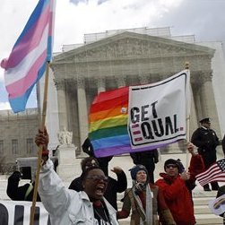 In this photo taken Wednesday, March 27, 2013, demonstrators holding flags chant in front of the Supreme Court in Washington. (AP Photo/. (AP Photo/Jose Luis Magana)