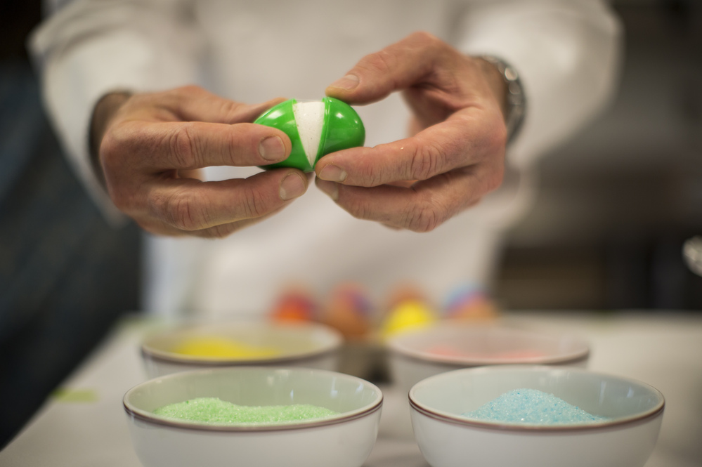 After the marshmallow has set, open the plastic shell and dip the egg in flavored and colored sugar, as Thomas Keller demonstrates here.