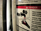 A warning label on a water heater. A warning label on a water heater.