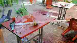 A photo released by the official Syrian Arab News Agency shows bloody tables and chairs in a Damascus University cafeteria that was struck by a mortar Thursday.