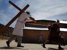 Students playing the roles of Roman soldiers lead a man playing the role of Jesus during a re-enactment of the Stations of the Cross at the Sanctuary of Chimayo in New Mexico on Thursday. Students playing the roles of Roman soldiers lead a man playing the role of Jesus during a re-enactment of the Stations of the Cross at the Sanctuary of Chimayo in New Mexico on Thursday.
