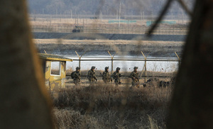 South Korean soldiers patrol along a barbed-wire fence near the border village of Panmunjom on Wednesday.