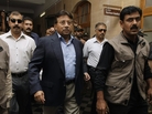 Former Pakistani President Pervez Musharraf (center) arrives in court in Karachi on Friday. An angry lawyer threw a shoe at Musharraf, who was not hit. He faces legal charges following his return to the country after four years in self-imposed exile, police said. Former Pakistani President Pervez Musharraf (center) arrives in court in Karachi on Friday. An angry lawyer threw a shoe at Musharraf, who was not hit. He faces legal charges following his return to the country after four years in self-imposed exile, police said.