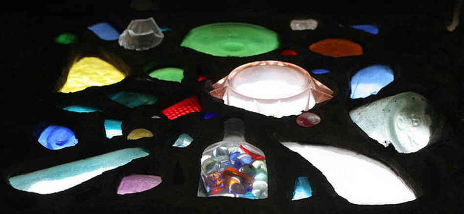 Old bottles and salvaged glass make up the "stained glass" windows in Broken Angel. Old bottles and salvaged glass make up the "stained glass" windows in Broken Angel.