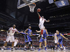 Louisville guard Russ Smith (2) goes up with a layup against Duke defenders during the first half of the Midwest Regional final in the NCAA college basketball tournament Sunday in Indianapolis. Louisville guard Russ Smith (2) goes up with a layup against Duke defenders during the first half of the Midwest Regional final in the NCAA college basketball tournament Sunday in Indianapolis.