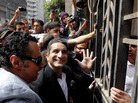 Television satirist Bassem Youssef waves to supporters as he enters Egypt's state prosecutors office to face accusations of insulting Islam and the country's Islamist leader in Cairo on Sunday. Television satirist Bassem Youssef waves to supporters as he enters Egypt's state prosecutors office to face accusations of insulting Islam and the country's Islamist leader in Cairo on Sunday.