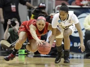 Louisville's Bria Smith, left, battles Purdue's April Wilson for a loose ball during their second-round game in Louisville, Ky., Tuesday.