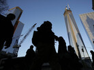 People pass the World Trade Center construction site in New York. Debris from the fallen towers will be sifted for victims' remains beginning Monday. People pass the World Trade Center construction site in New York. Debris from the fallen towers will be sifted for victims' remains beginning Monday.