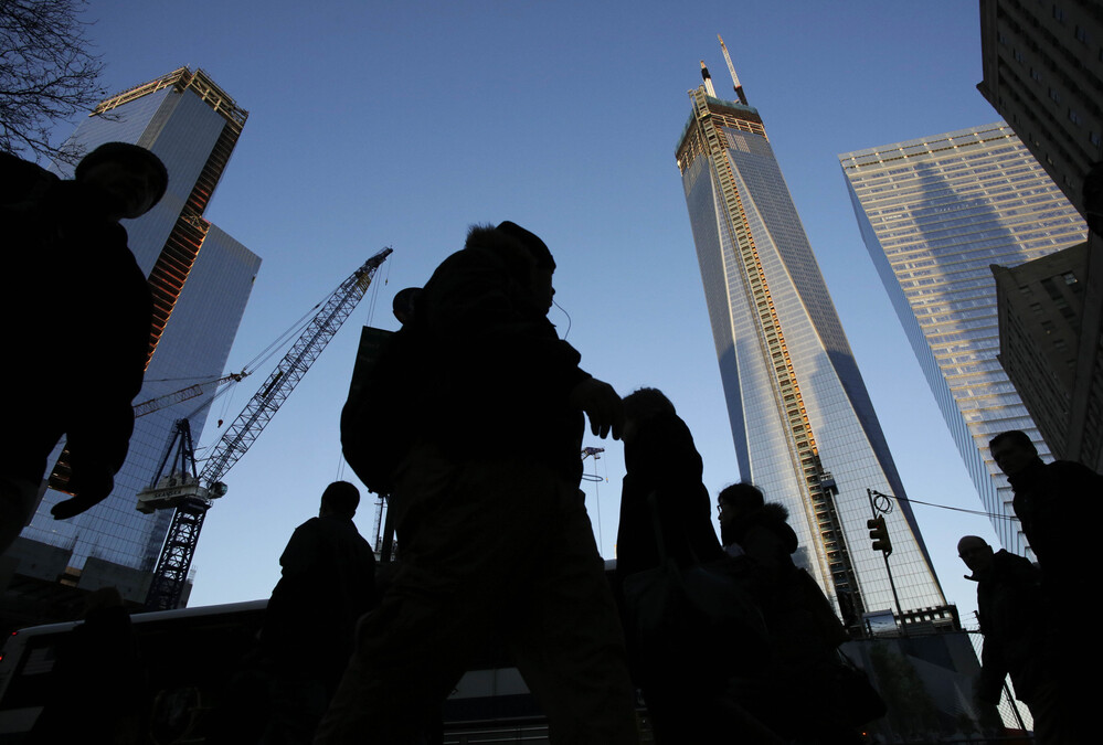 People pass the World Trade Center construction site in New York. Debris from the fallen towers will be sifted for victims' remains beginning Monday. People pass the World Trade Center construction site in New York. Debris from the fallen towers will be sifted for victims' remains beginning Monday.