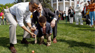 President Barack Obama helps a young participant roll an egg during the White House Easter Egg Roll on the South Lawn of the White House on April 9, 2012 in Washington, DC. President Barack Obama helps a young participant roll an egg during the White House Easter Egg Roll on the South Lawn of the White House on April 9, 2012 in Washington, DC.